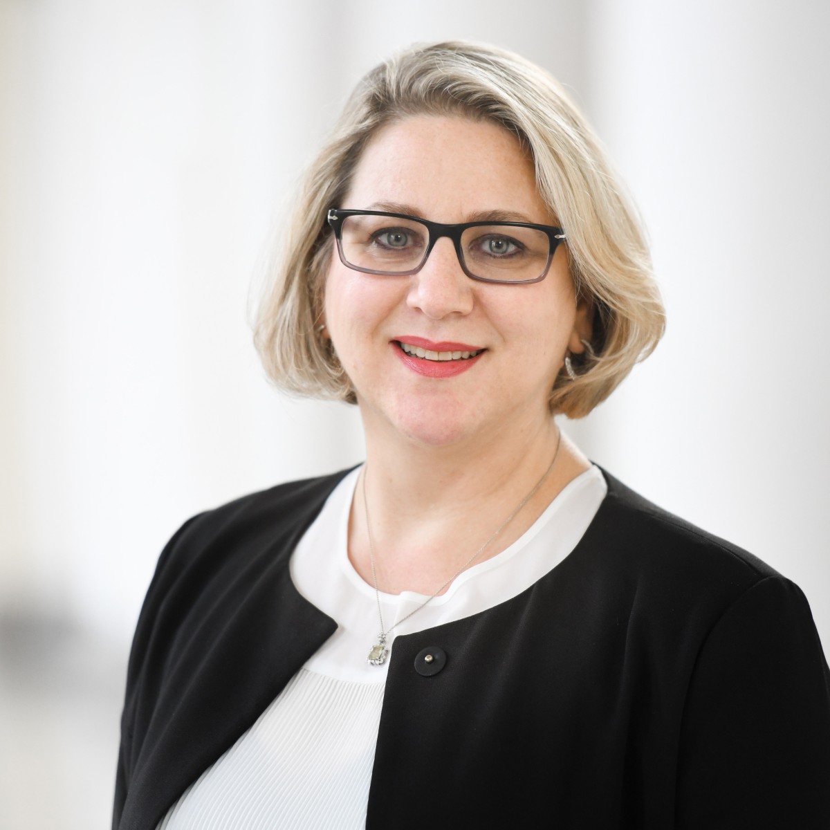 Jelena Spanjol wearing a white dress shirt and black coat