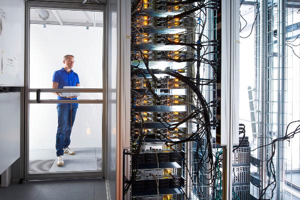 Picture of T. Straub in a server room