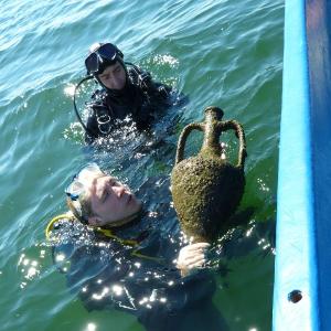 Divers rescue an old antique amphora