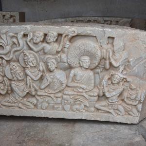Buddha and his disciples carved in bright stone