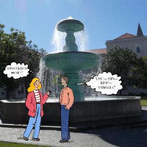 Illustration von zwei Studierenden vor einem Brunnen auf einem Universitätscampus. Eine Person fragt auf Türkisch: „Türkçe biliyor musun?“ („Sprichst du Türkisch?“). Die andere antwortet zögerlich: „Evet… yani… biraz… vielleicht.“, was Unsicherheit über die eigenen Türkischkenntnisse ausdrückt.
