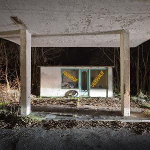 Run-down building by a forest.