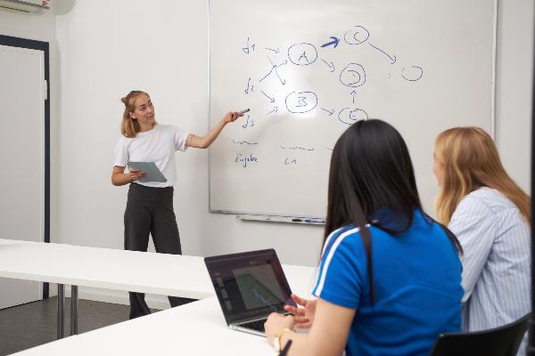 A lecturer explains a data processing model in the course