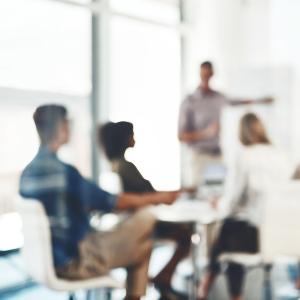 People in a bright meeting room watching a presentation. | © iStock People in a bright meeting room watching a presentation.