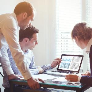 Group of professionals discussing something over laptops and documents. | © Anya Berkut Group of professionals discussing something over laptops and documents.