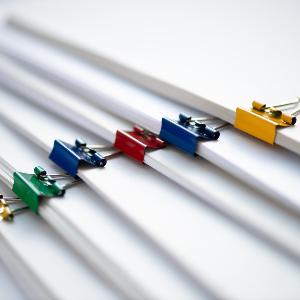 Paper pinned together with colorful staples