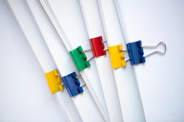 Paper pinned together with colorful staples