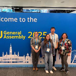 Elisabeth Probst, Mariangela Varela, Christoph Jörges, and Prof. Marianela Fader in front of the EGU 2025 banner.