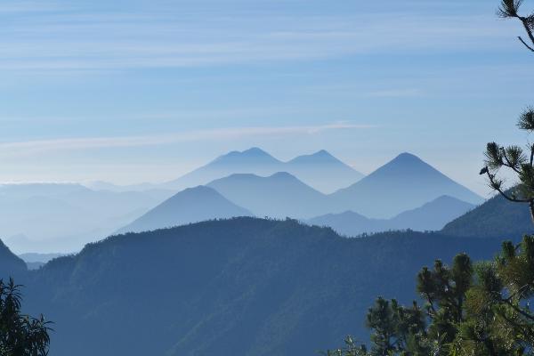 Guatemalan volcanoes seen from the top of Santa Maria volcano. The picture was taken in June 2016 and shows in the foreground Volcán de Atitlán and in the background the Volcán de Fuego and Acatenango
