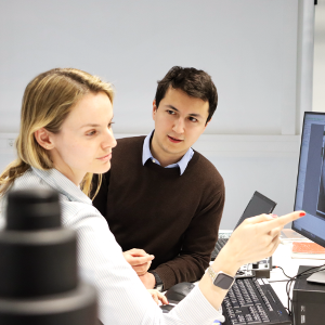 Discussing results: Melisande Kost (left) and Arthur Ermatov (right) discuss the recorded X-ray spectra describing the deposited materials on the crystals (seen on the screen).