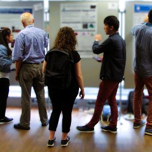 Researchers discussing at a poster session
