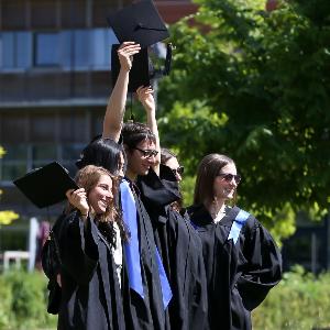 GSN alumni posing during Graduation Day wearing caps and gowns