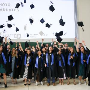 GSN Graduates throwing caps in the air during ceremony