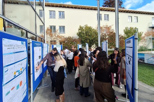 Poster session at GSN retreat with students discussing their projects in front of poster boards