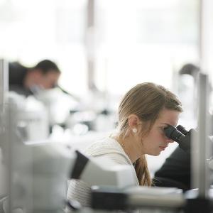 Student with microscope in practical class