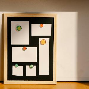 Framed board with blank stickers placed on floor