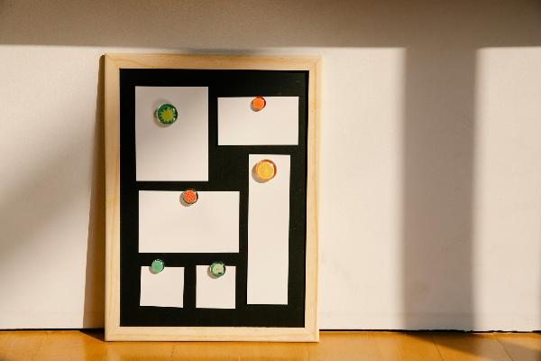 Framed board with blank stickers placed on floor