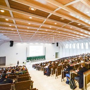 Large auditorium filled with students during a lecture