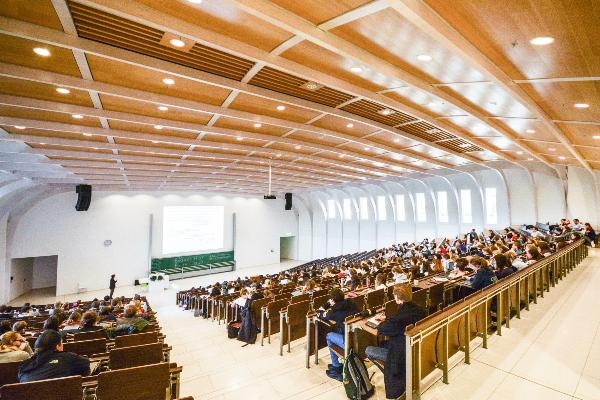 Large auditorium filled with students during a lecture