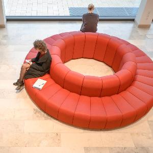 Zwei Studentinen sitzen auf einer runden Couch im Philologikum.