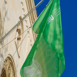 Green flag with LMU seal hangs on LMU main building