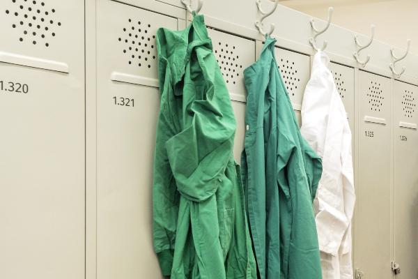 3 doctor gowns on a locker
