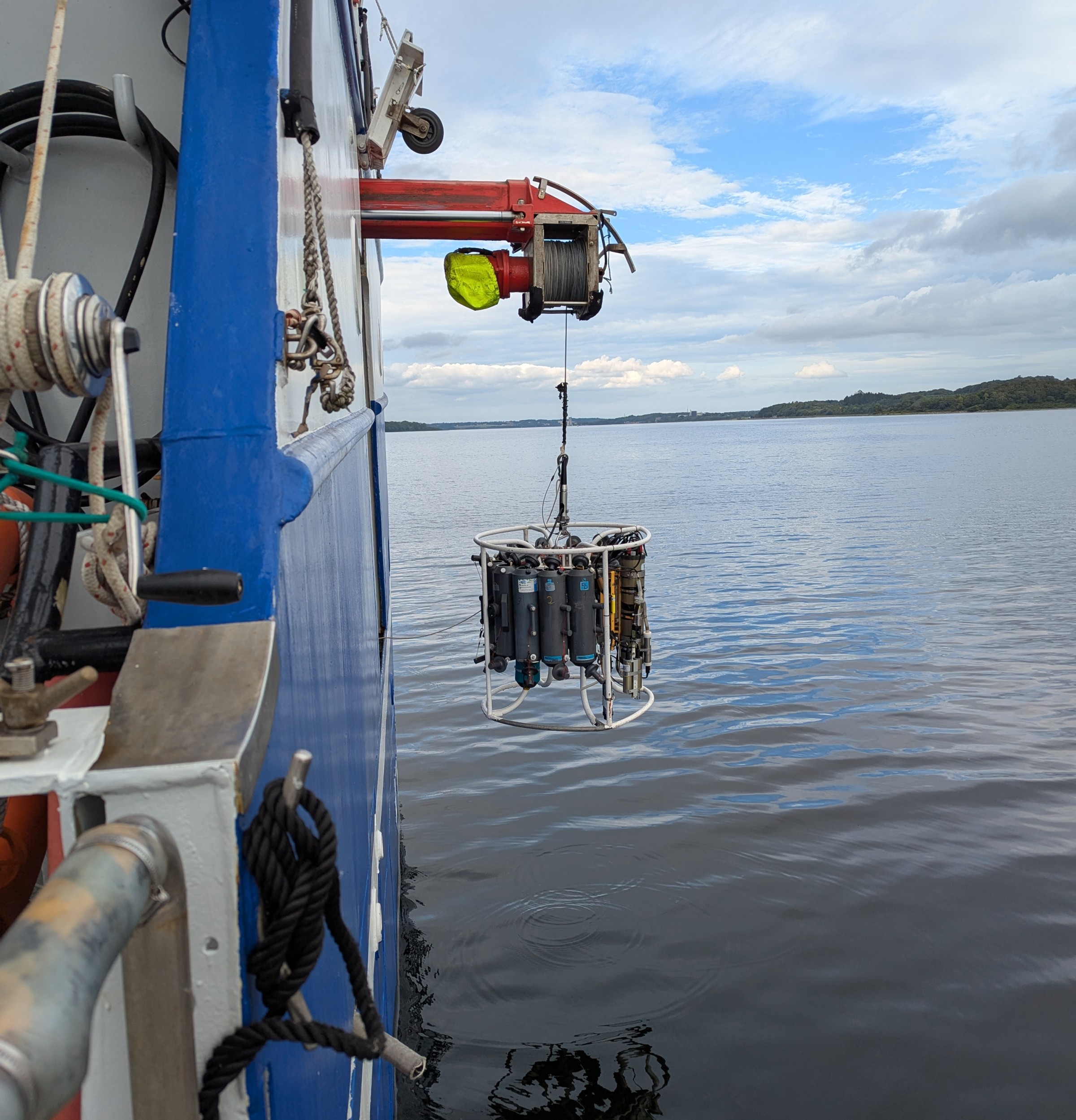 A CTD rosette is lowered into the water from the research vessel Aurora.