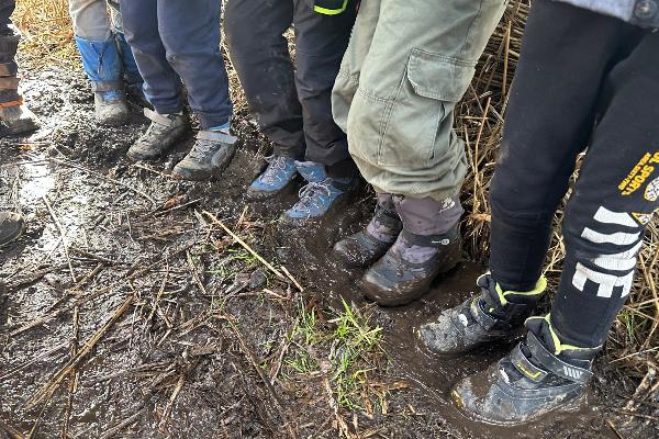 Close-up of children´s rubber boots in the mud