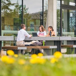 Studierenden sitzen an einem Tisch