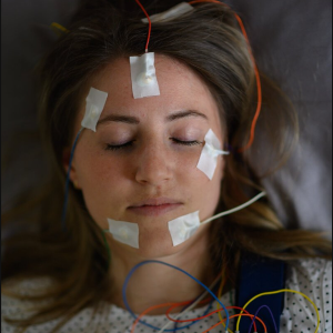 Test person in the sleep laboratory, wired with EEG electrodes