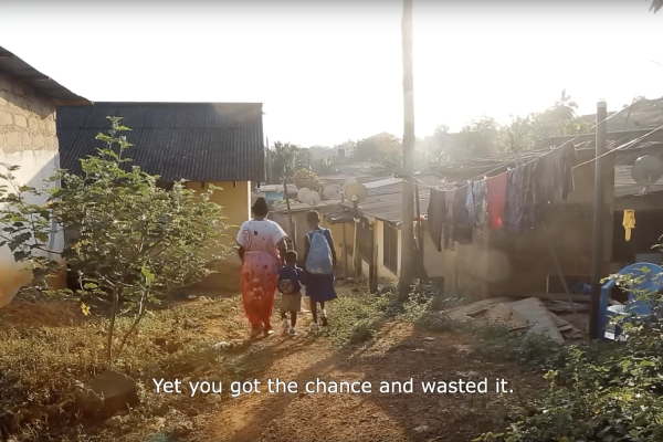 Der Screenshot aus dem Trailer Fati’s Choice zeigt eine Gruppe von Menschen von hinten, die einen Feldweg entlanggehen.