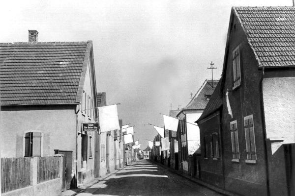 At the beginning of 1945, the inhabitants of a village hung white flags from the windows of their houses as a sign of surrender.