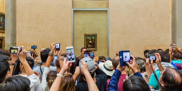 Besucher fotografieren die Mona Lisa im Louvre.