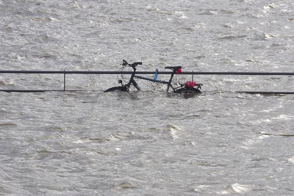Ein Fahrrad ist nach einer Sturmflut halb überspült.