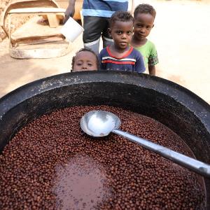 Children wait for free meal at a charity kitchen