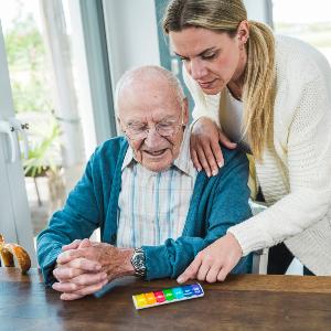 A woman takes care of an elderly gentleman