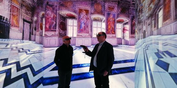 Two men are standing in a 3D reconstruction of the Kaisersaal in the Bamberg Residence.