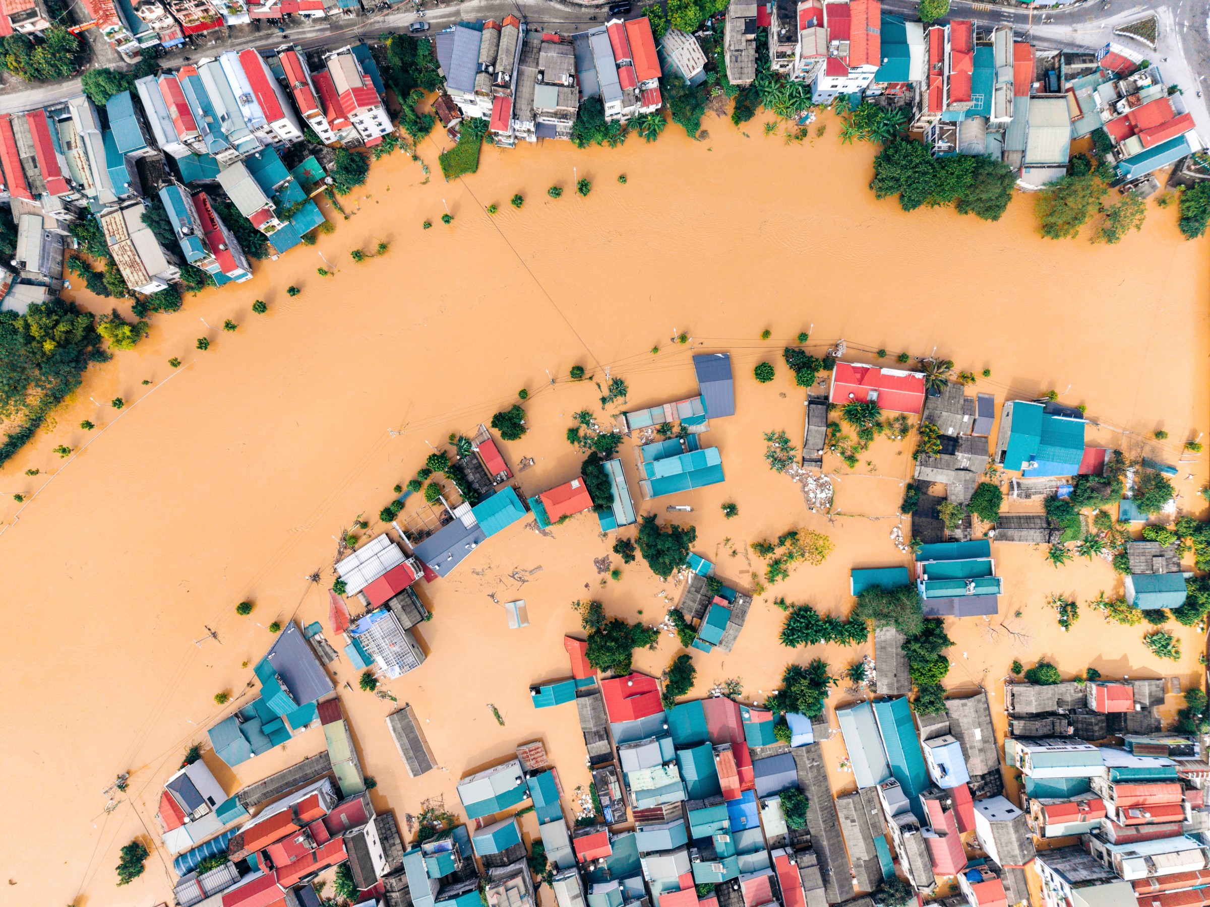 Cao Bang city, Cao Bang, Vietnam Aerial view of flooded town with submerged colorful houses along a curved river. Cao Bang city, Cao Bang, Vietnam